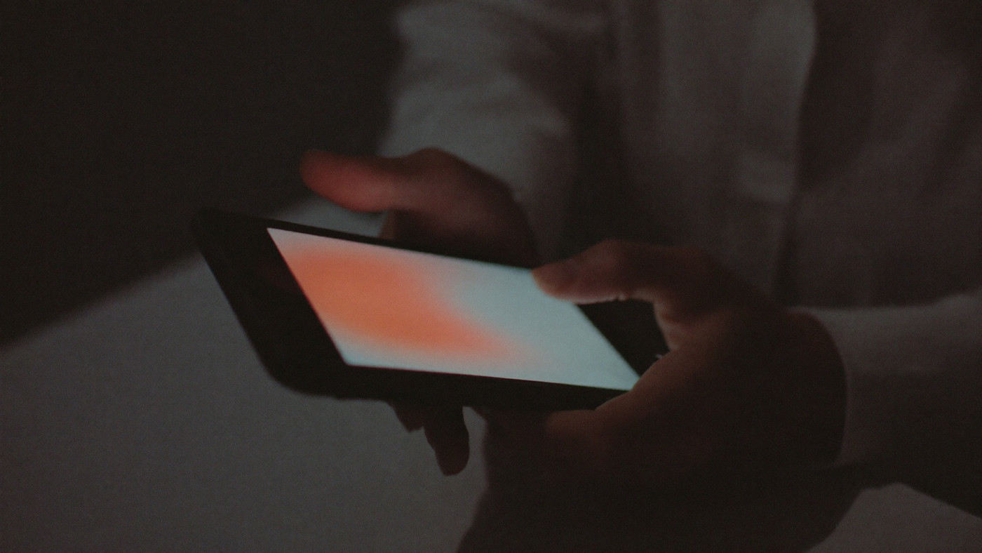 Close view of a hand holding a phone in portrait with a game open on the screen